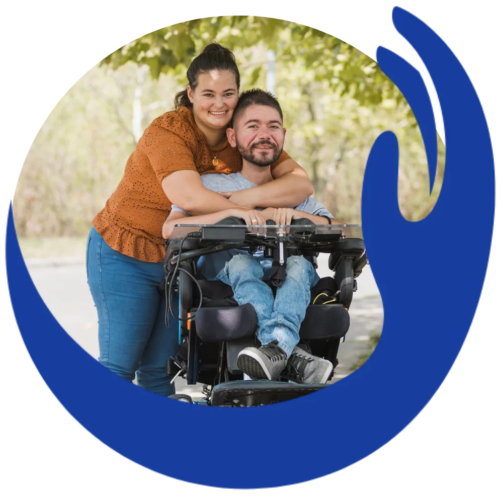 Disabled man in wheelchair hugging support worker