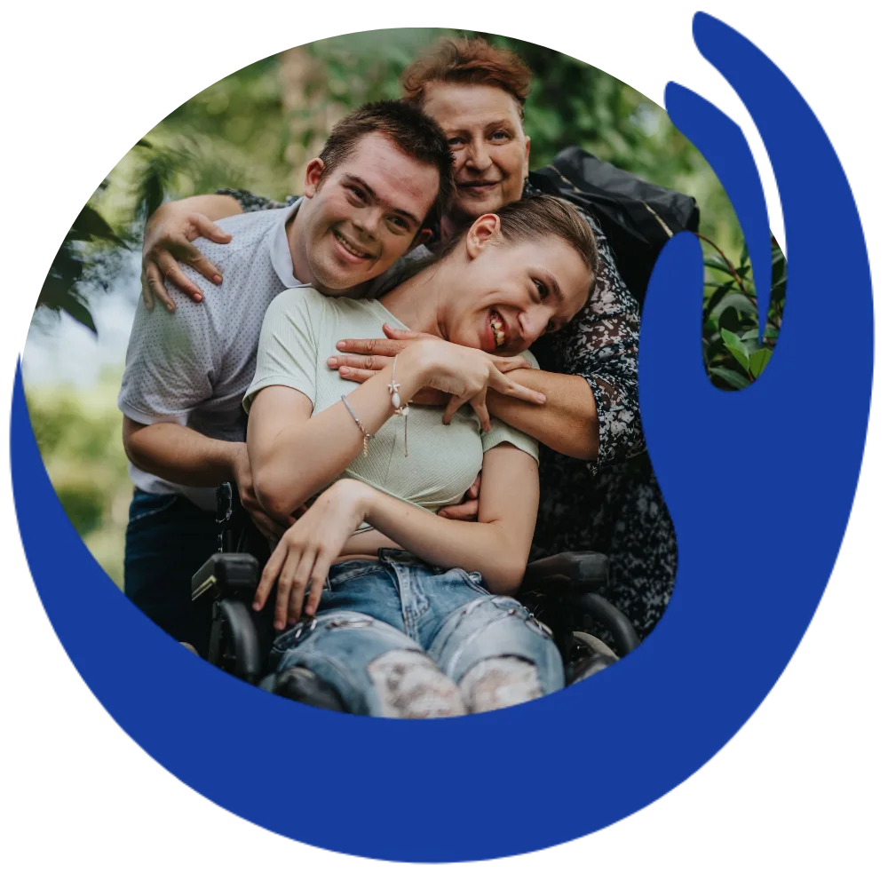 Two disabled friends and support worker all hugging