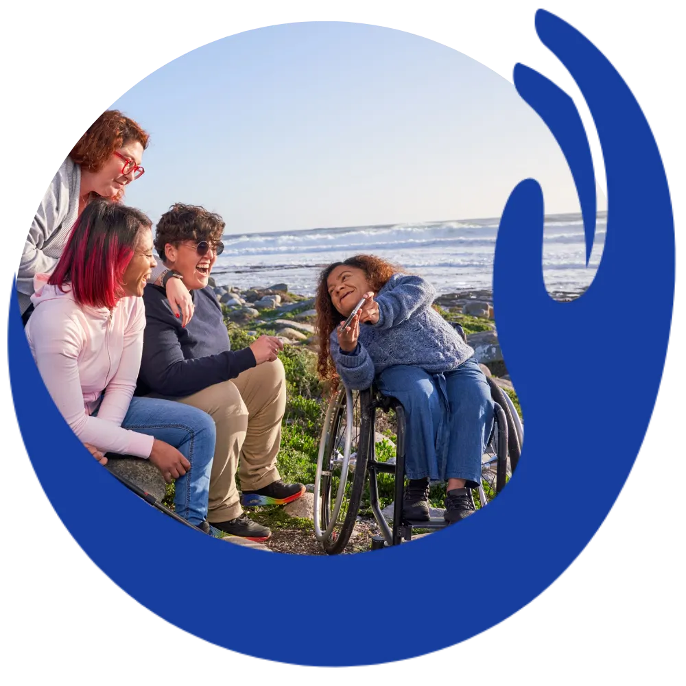 Disabled woman in wheelchair smiling with friends