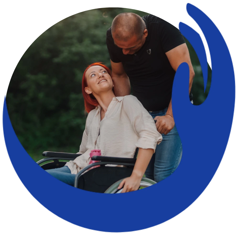 Disabled woman in wheelchair smiling with support worker